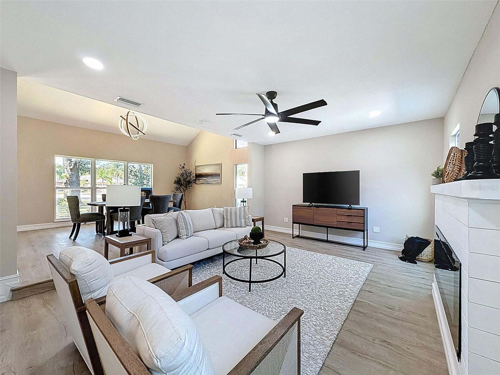 Spacious living room with electric fireplace.