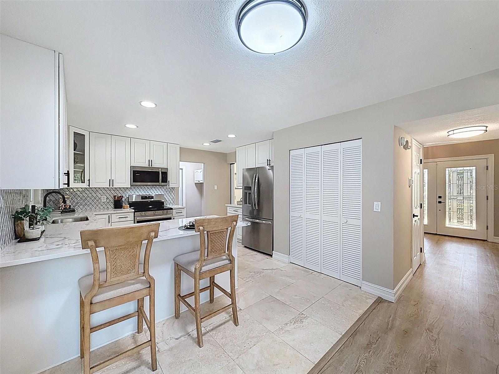 Modern kitchen with breakfast room overlooking the pool.