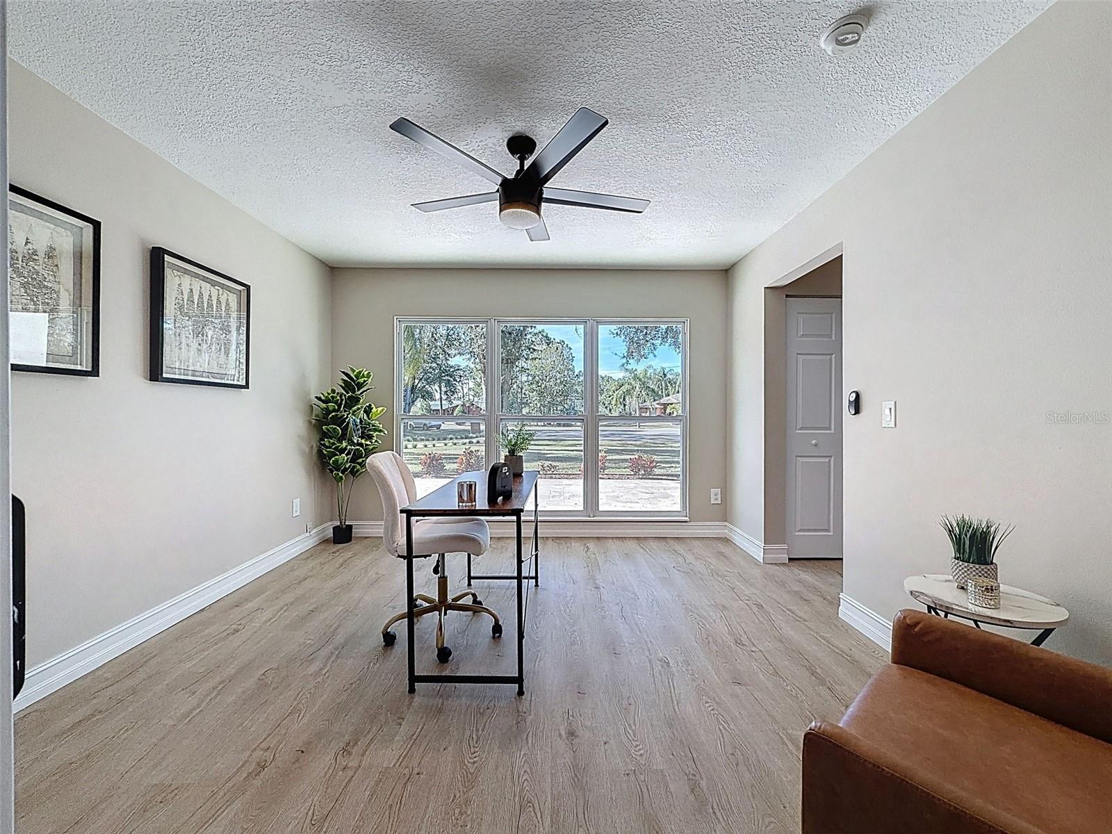 Front formal dining room staged as an office.