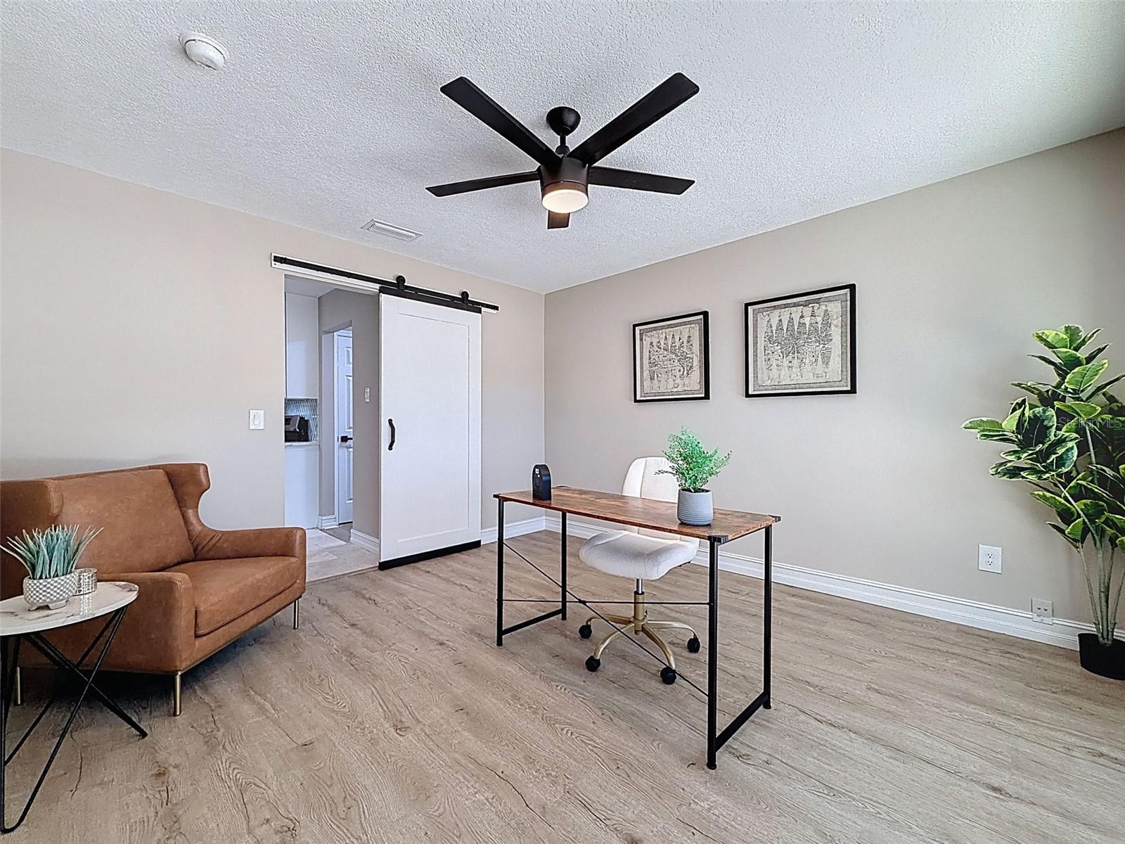 Front formal dining room staged as an office.