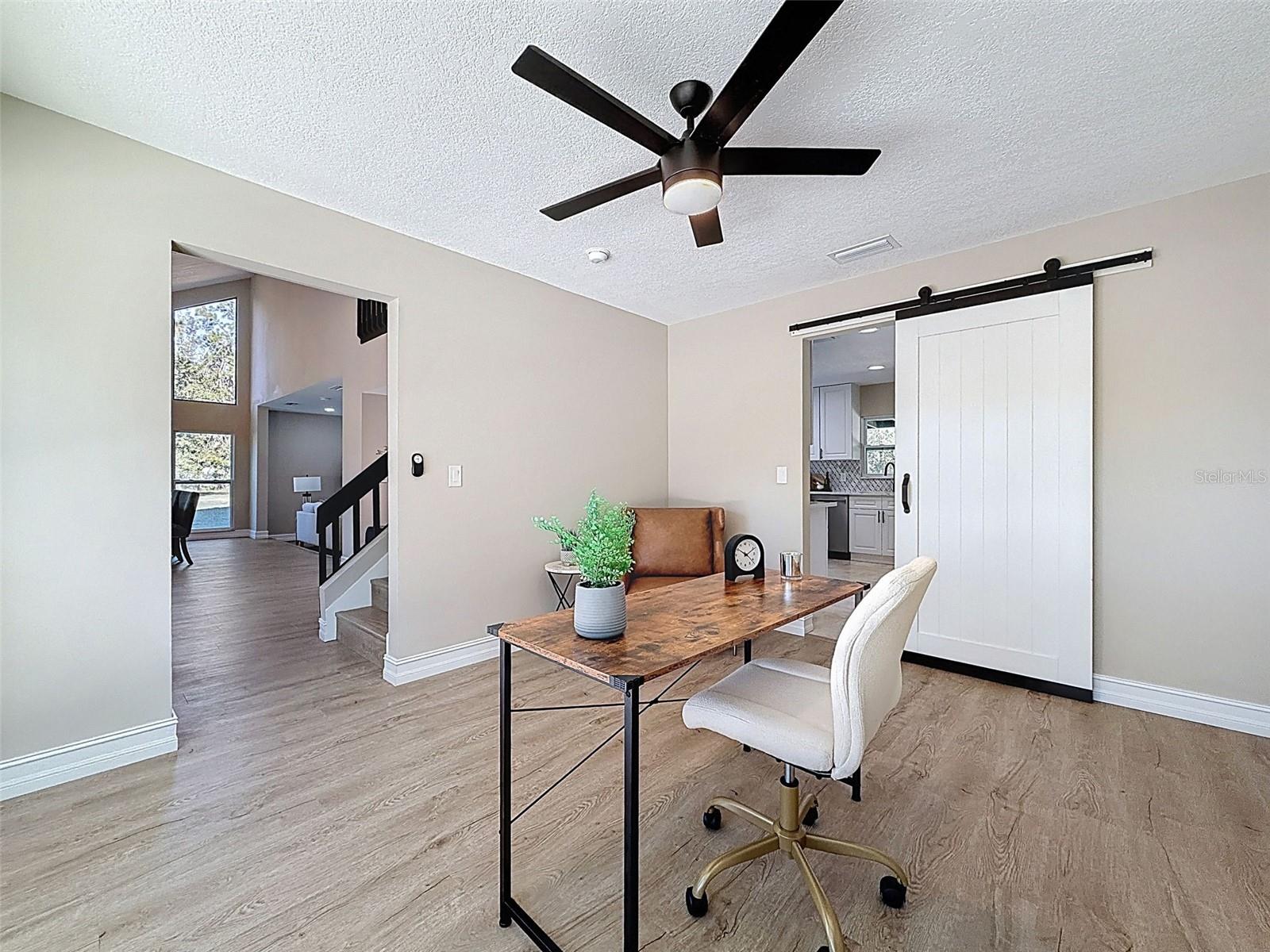 Front formal dining room staged as an office.