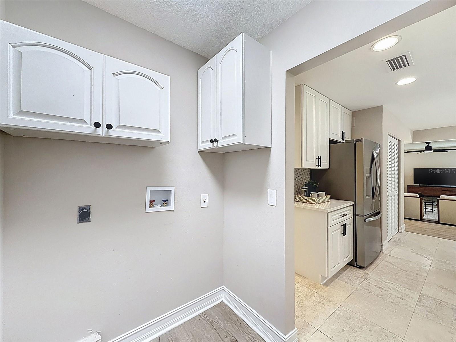 Laundry room off the kitchen leading to powder room and garage.