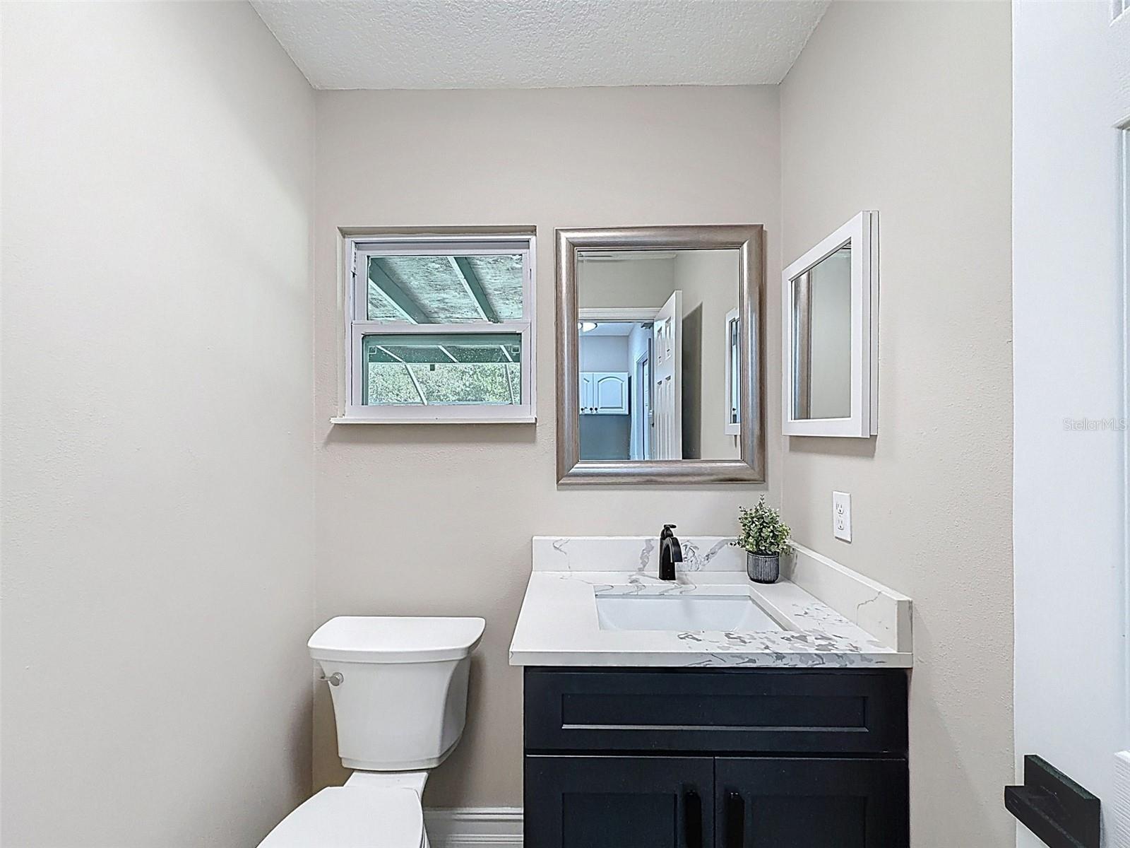 First floor powder room for guests and pool users.