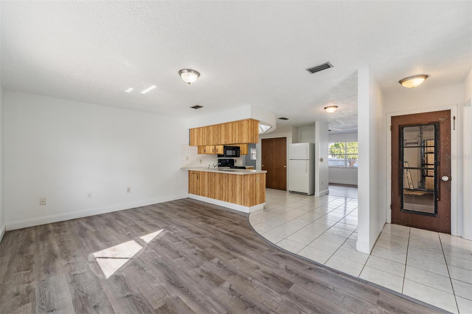 Family room.  Hallway leads to full bathroom and garage.