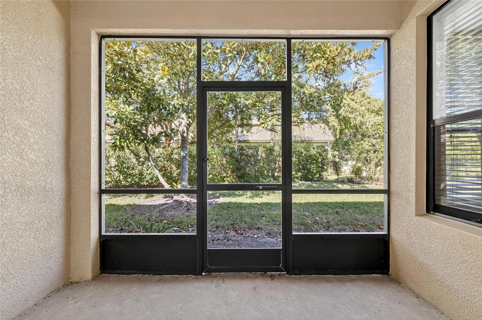 Looking through the glass sliders into the private lanai. Window on the right is from the owners suite.