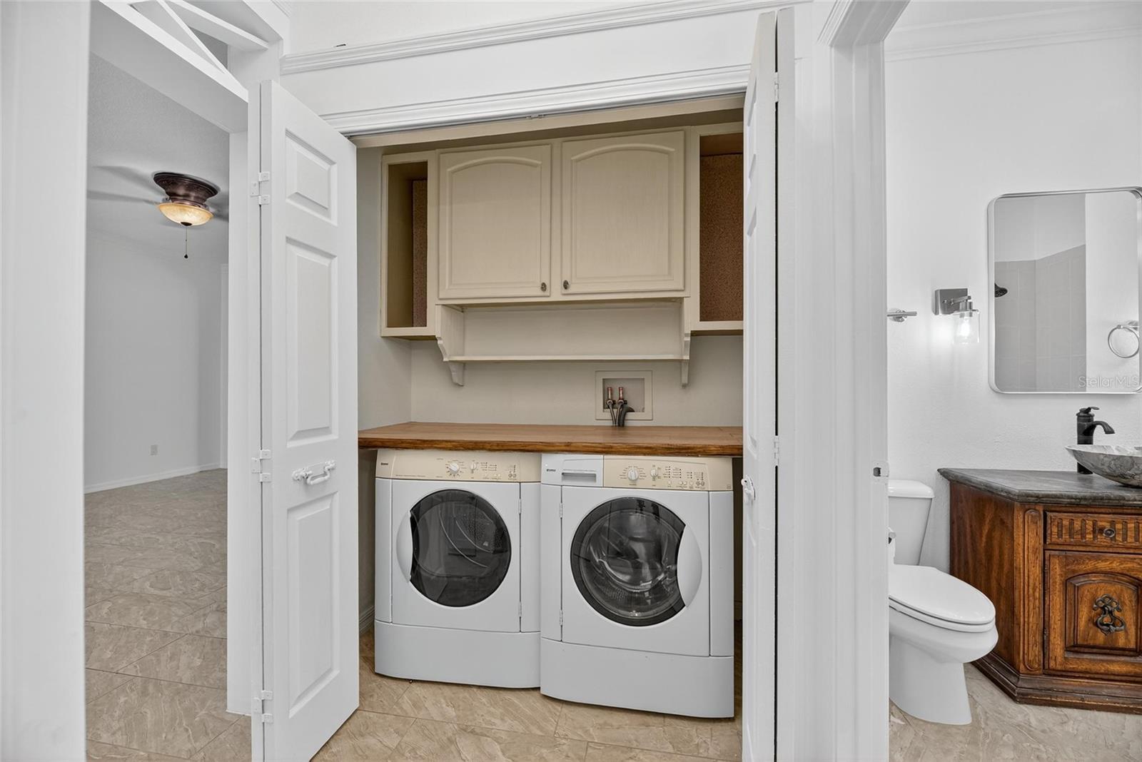 Laundry closet with view of the guest bathroom.