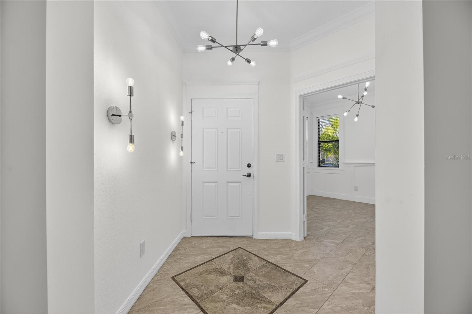 Looking at front door from the inside with study/den on the right. Notice the detailing in the floor!