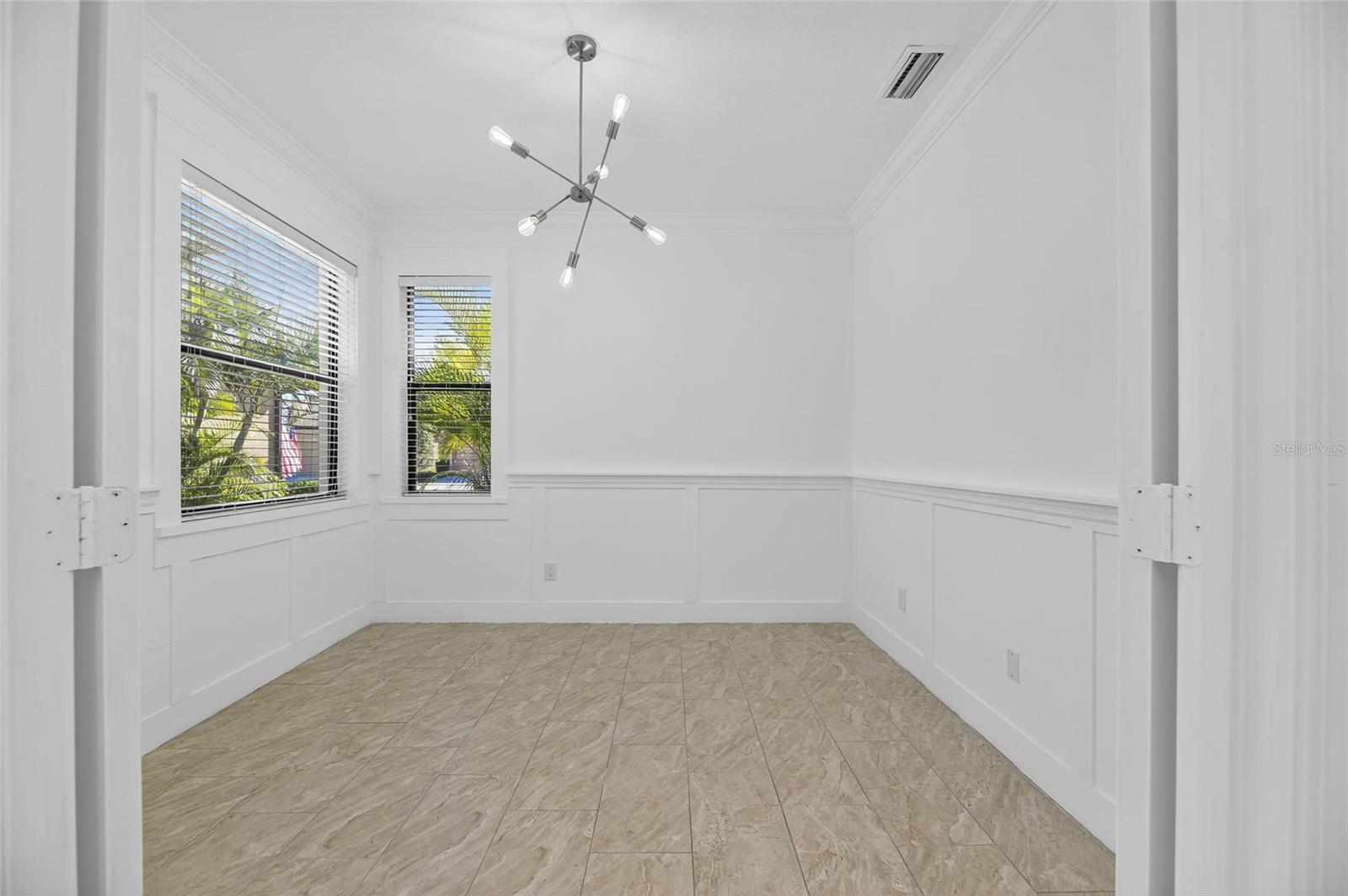 Looking inside the study/den. Check out the chair rail and detailing on the walls along with the crown molding.