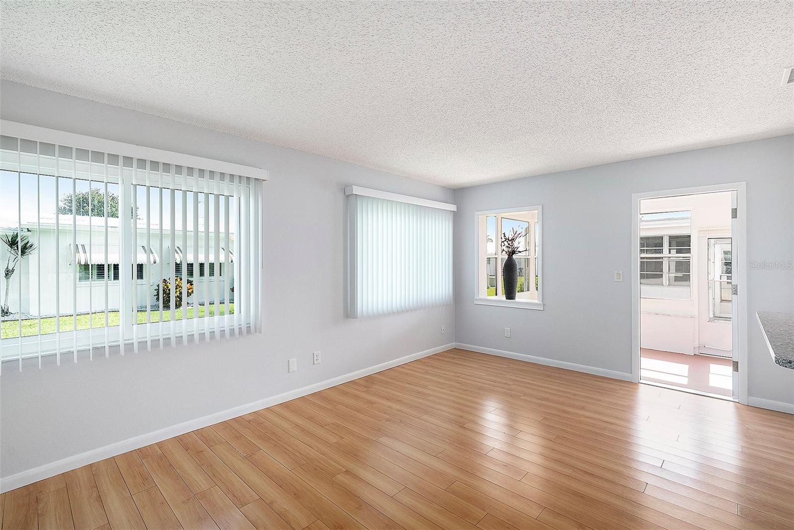 Dining room view into the enclosed Sunroom (AC)