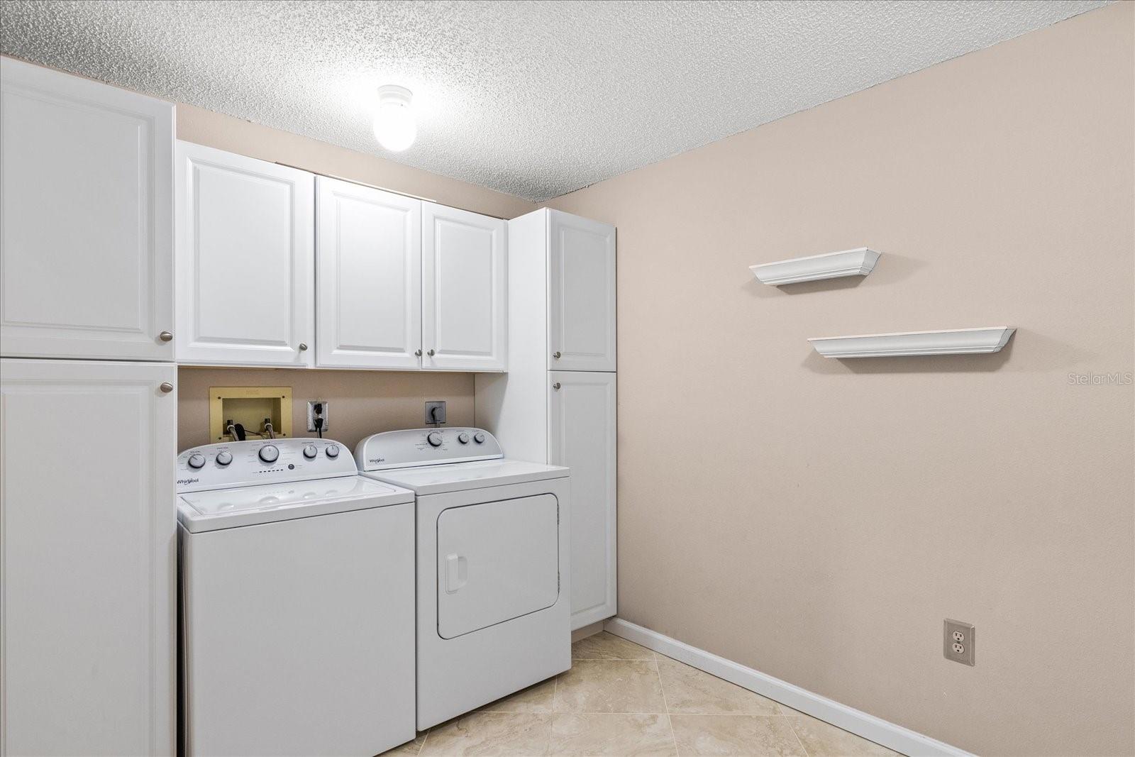 one end of the laundry room with wonderful storage