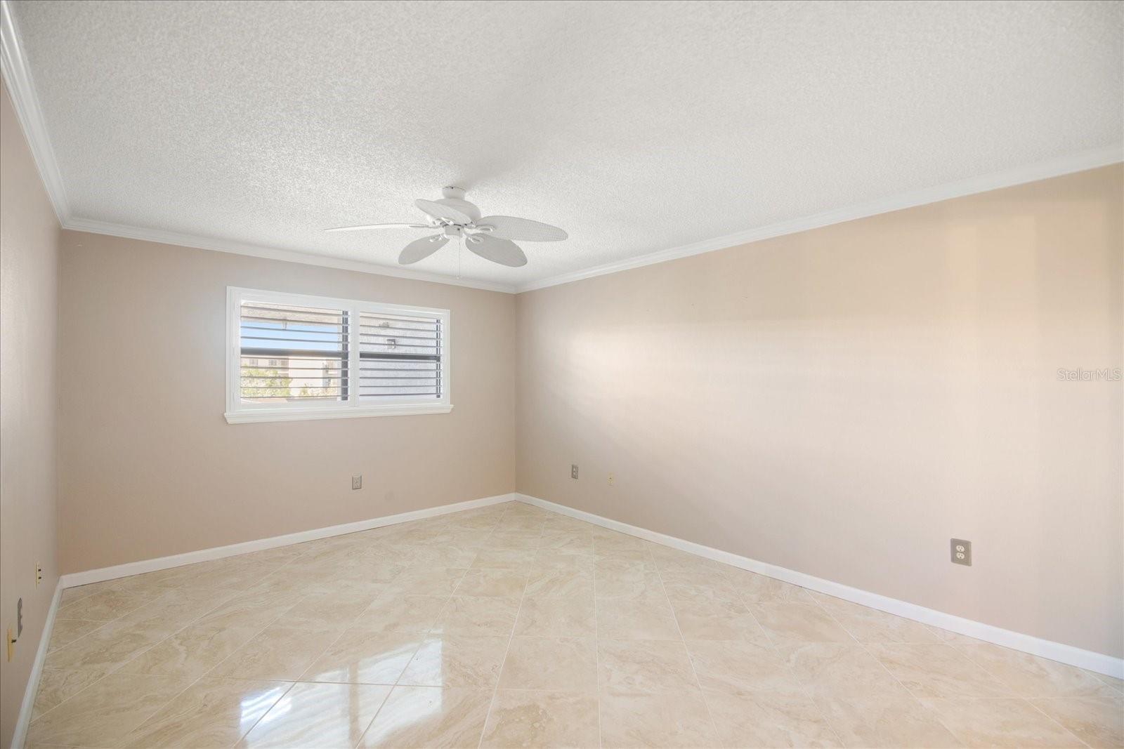 Primary bedroom with lots of wall space and gorgeous shutters