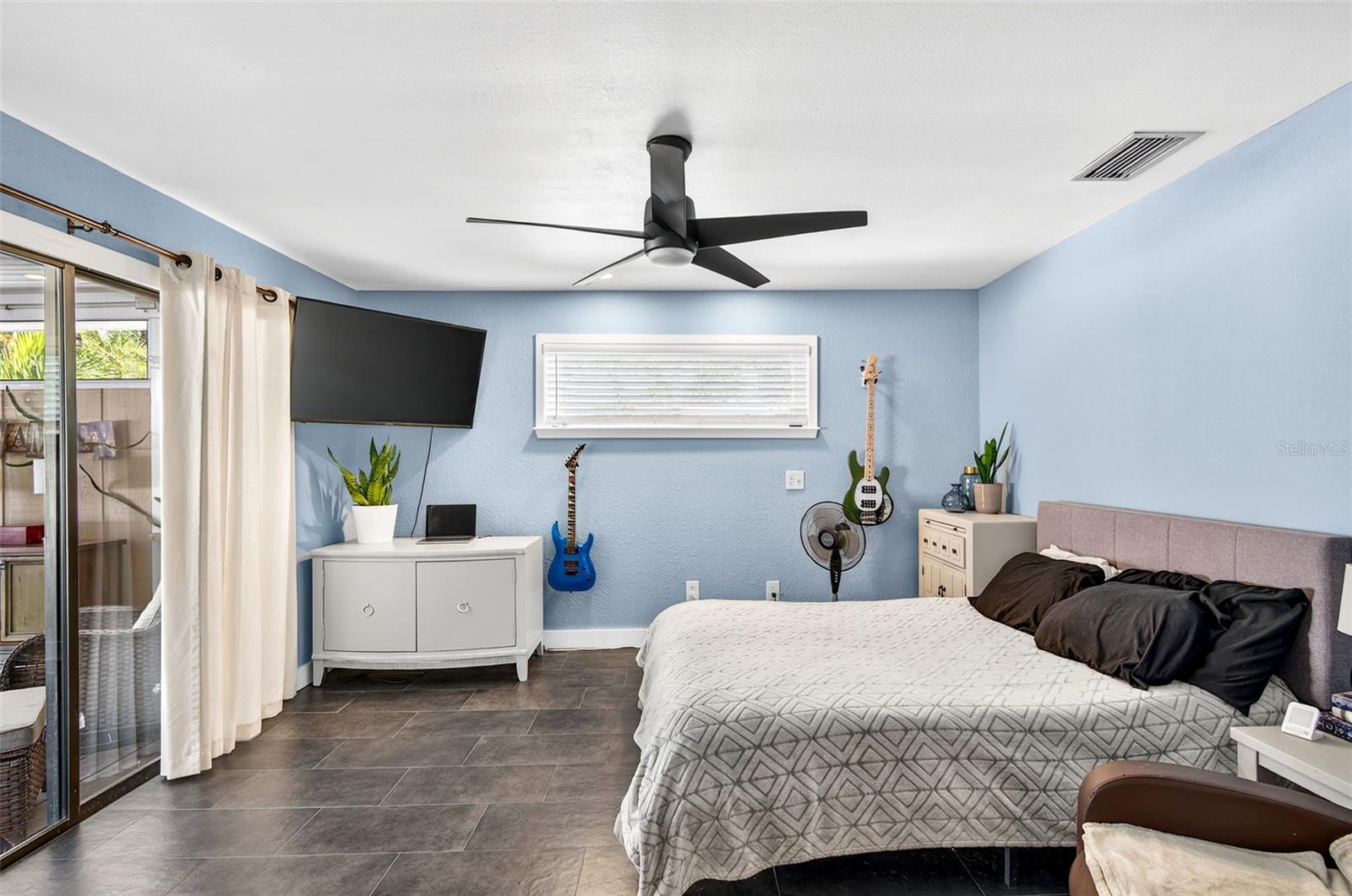 bedroom 3 with slider to outside screened in porch