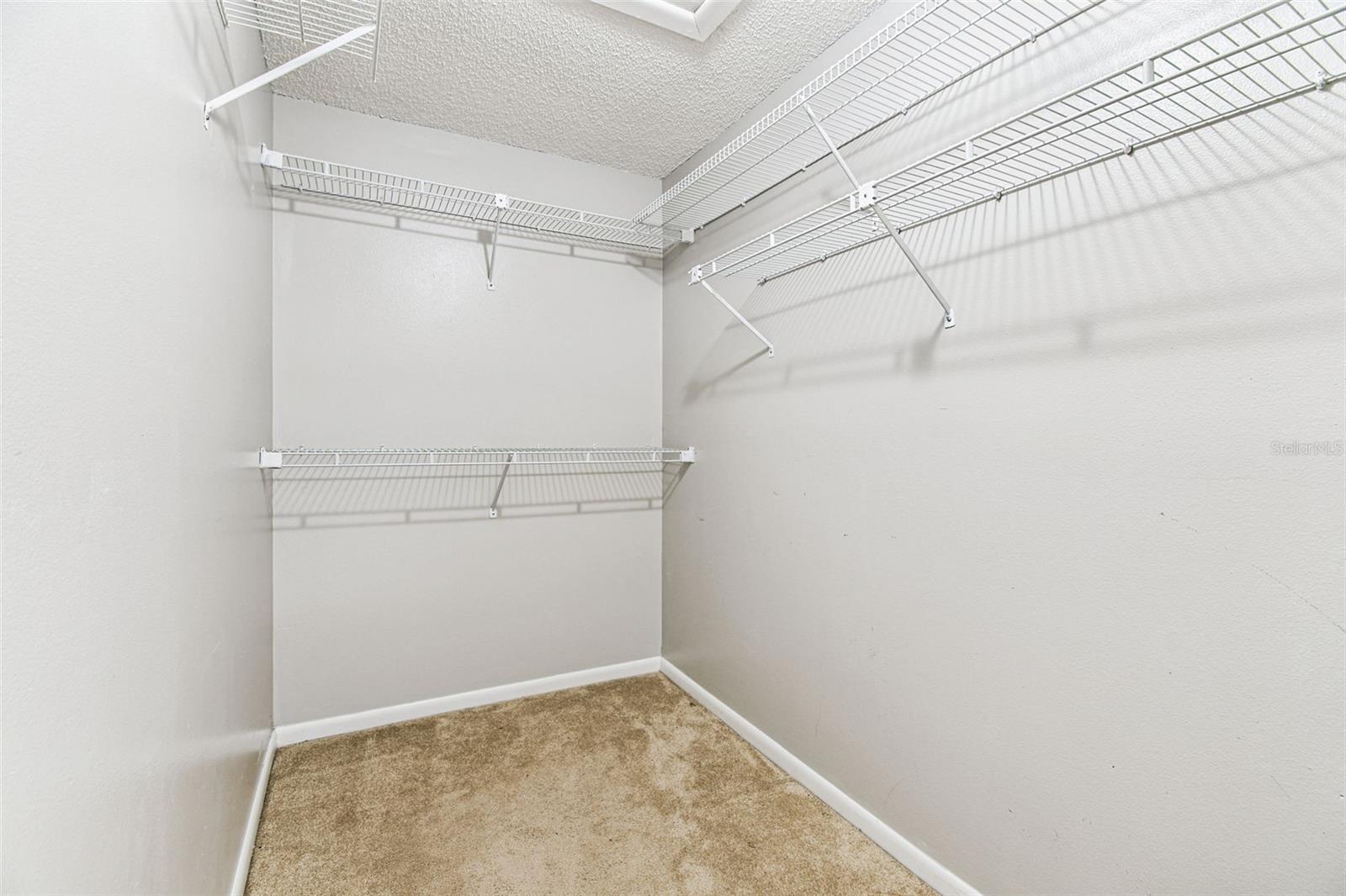 Walk in closet in primary bedroom