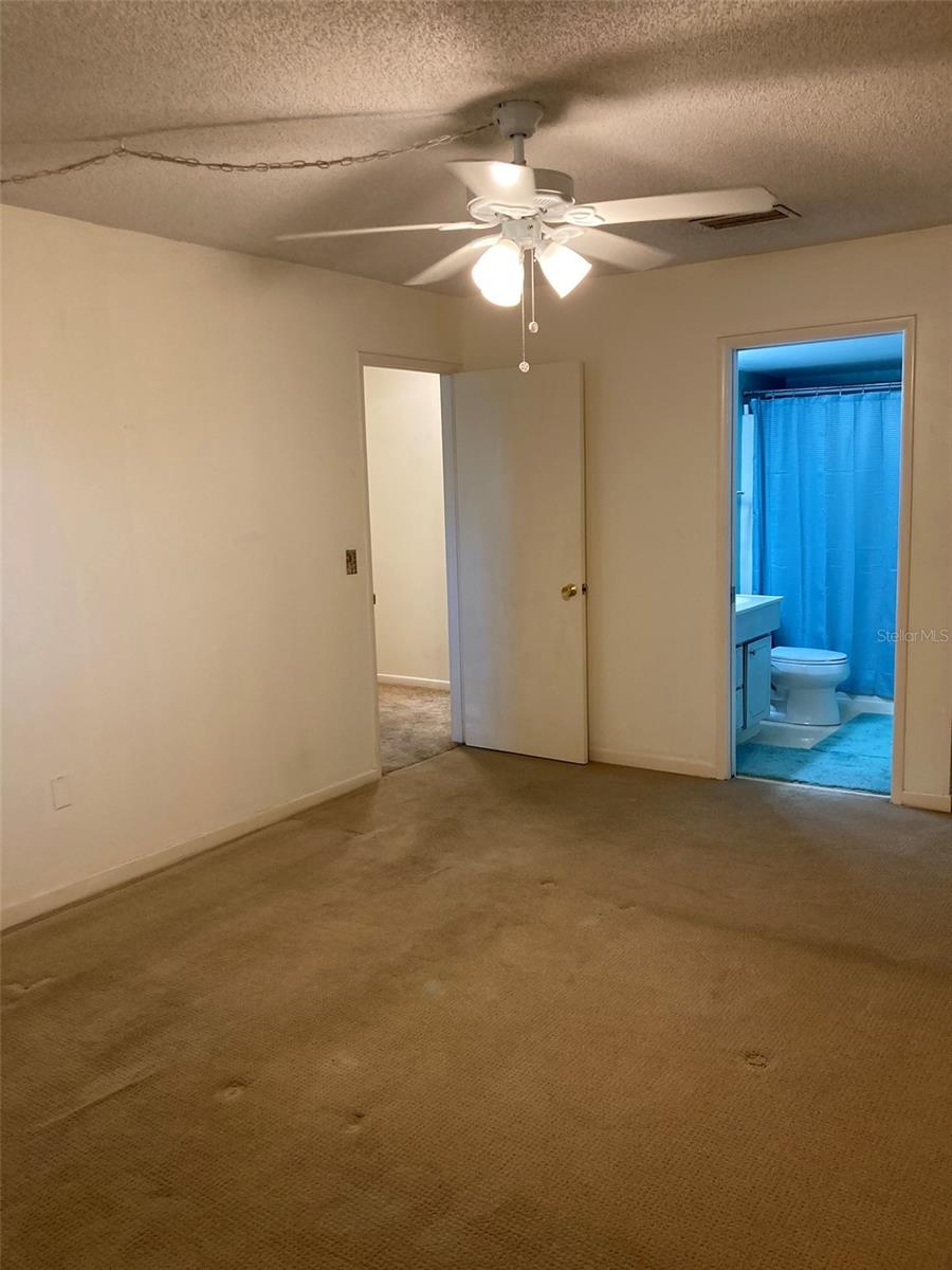 Master bedroom and bathroom with a step in shower