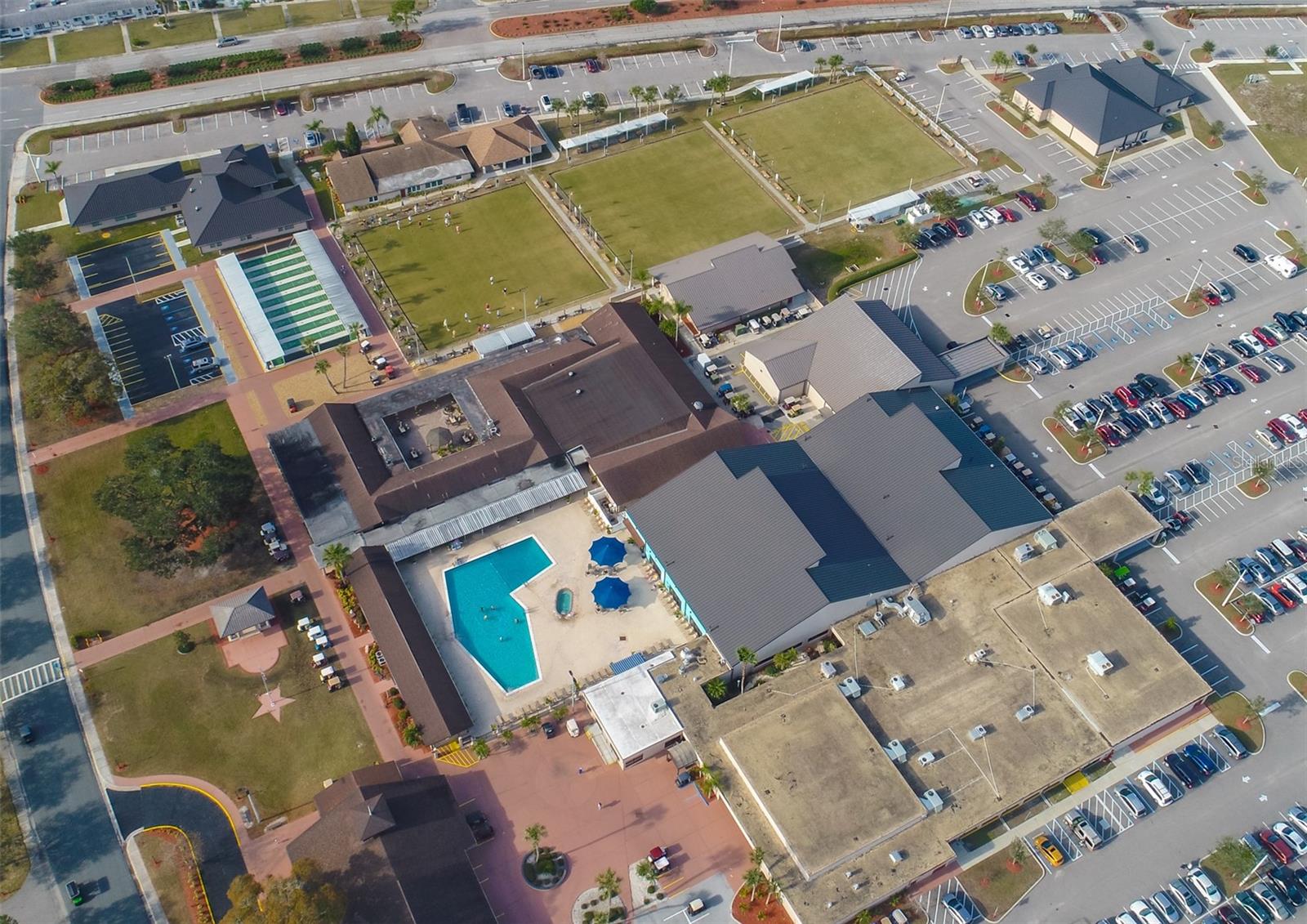 9.0 Ariel View of Sun City Center Association Community Center showing the outdoor pool complex, shuffle board and Bauchi Ball courts.