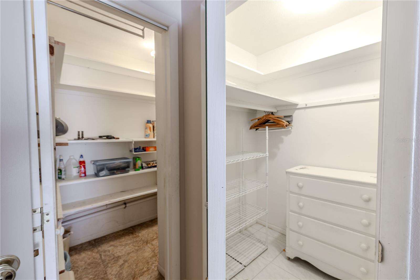 View of the master bedroom showcasing the roomy walk-in closet, perfect for organized and accessible storage. The entrance to the laundry room is conveniently located just steps away, making daily routines effortless. This thoughtful layout combines comfort and functionality, creating a cozy and practical retreat within the master suite.