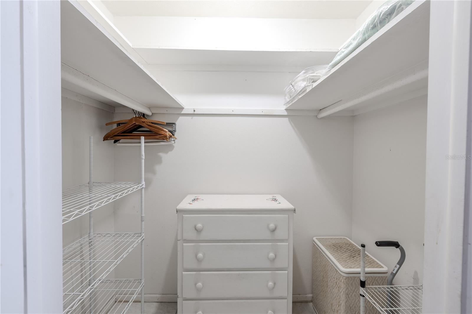 Full view of the master bedroom showcasing the roomy walk-in closet, perfect for organized and accessible storage and practical access within the master suite.