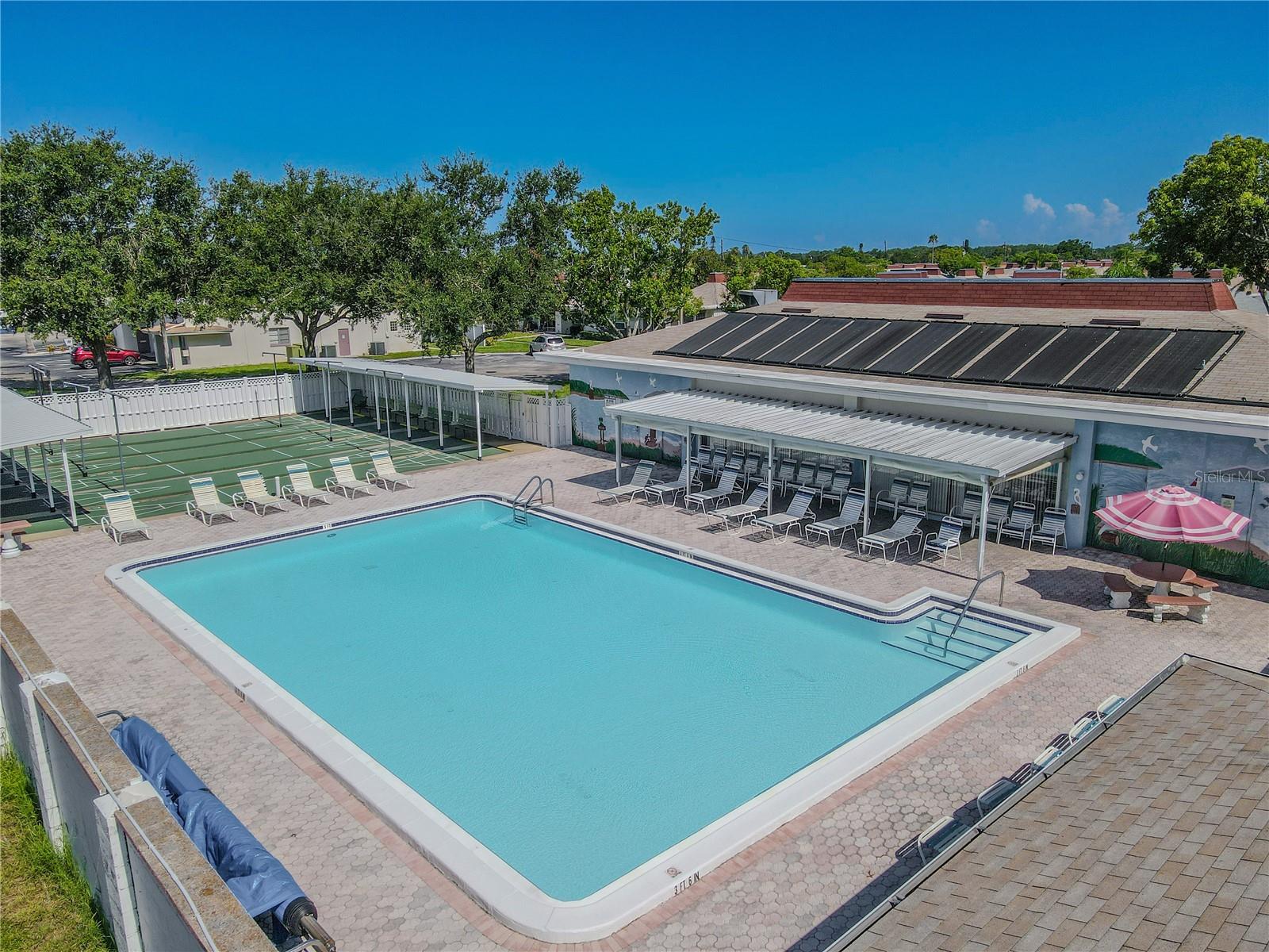 This beautiful community resort-style pool offers expansive deck space and abundant seating, perfect for relaxing, socializing, and enjoying time with friends. The well maintained pool area serves as a central gathering spot, providing a fun and inviting atmosphere for residents.
