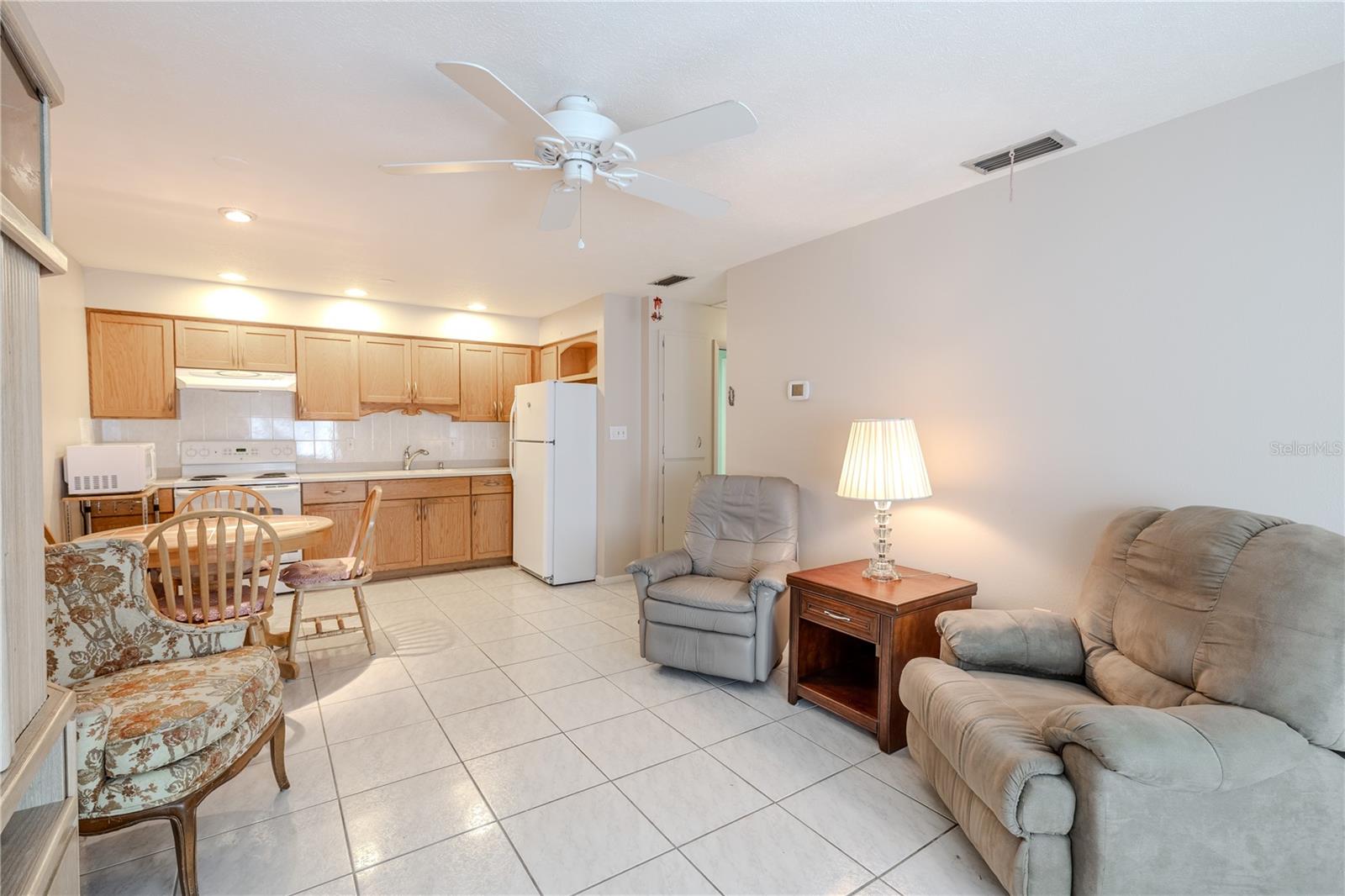 Bright, open living space seamlessly connecting to the kitchen, with effortless access to the bedrooms and bathroom. The airy layout creates a natural flow throughout the home, perfect for comfortable daily living, entertaining, and easy movement between rooms. Sunlight fills the space, enhancing the inviting atmosphere and highlighting the thoughtful design.