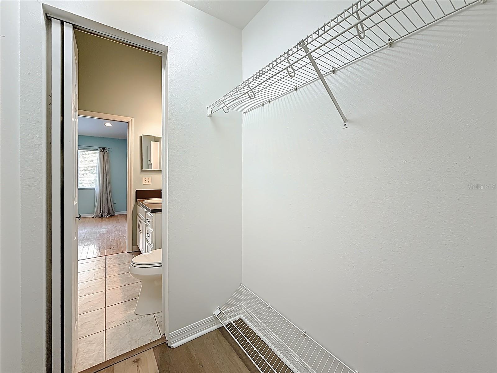 Primary bedroom walk-in closet