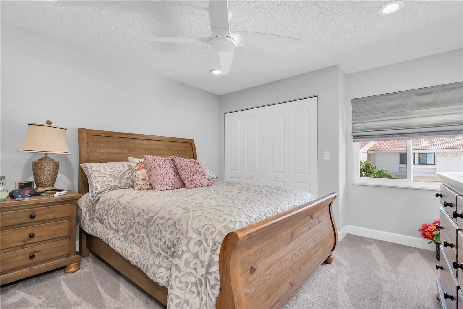 Bedroom #2 with recessed lighting, ceiling fan and wall storage closet