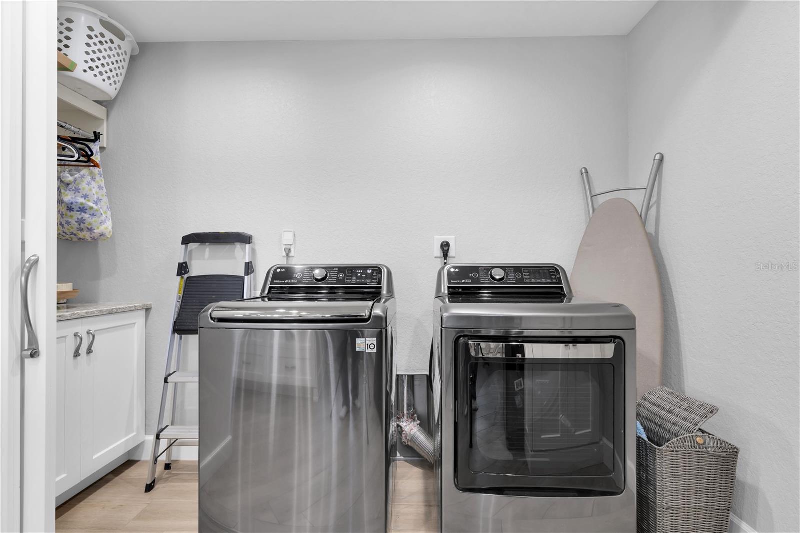 Laundry room is located discreetly off the kitchen, hidden behind a clever door system