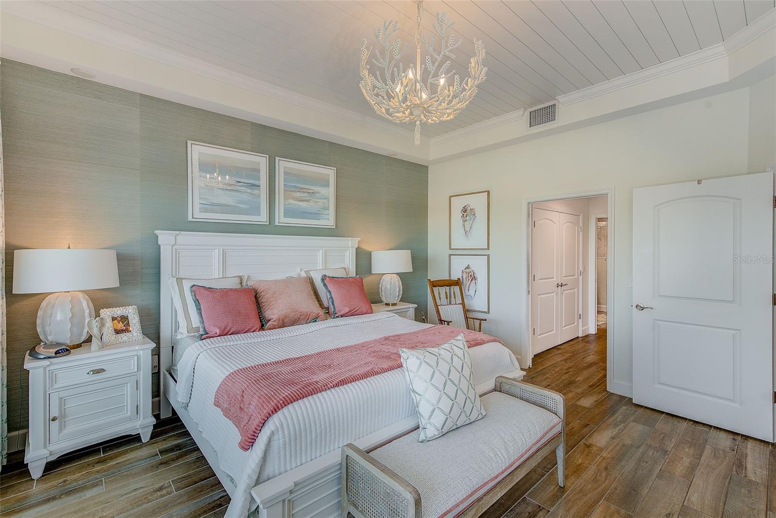 Primary Suite with sea glass colored grass cloth behind the bed