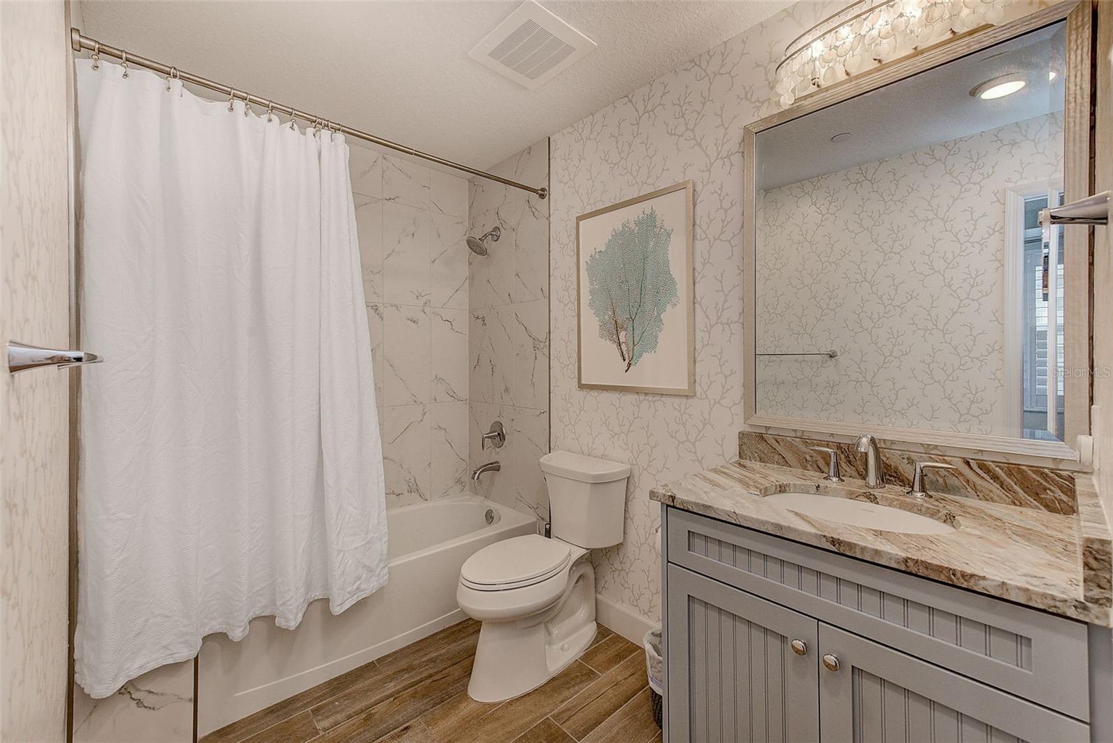 Guest bathroom: beautiful vanity with beadboard detailing in the cabinetry