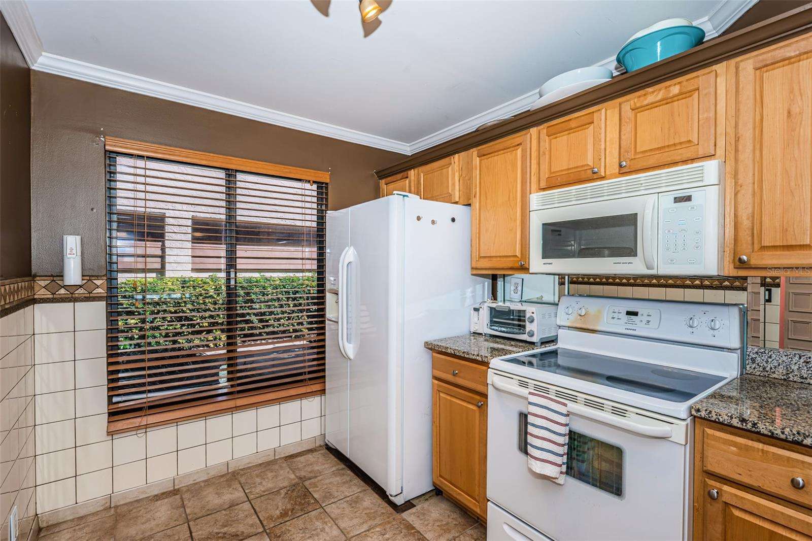 Kitchen with Pretty Cabinetry and  Granite Countertops