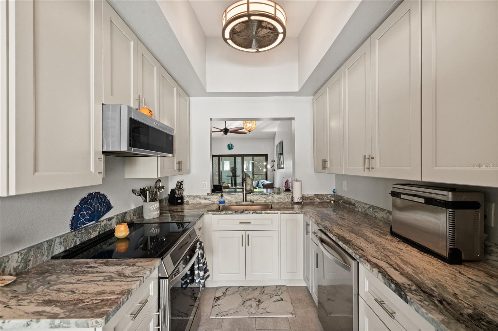 COMPLETELY UPDATED KITCHEN - FLOORING, CABINETS, GRANITE COUNTERTOPS, STAINLESS STEEL APPLIANCES, FAN/LIGHTING