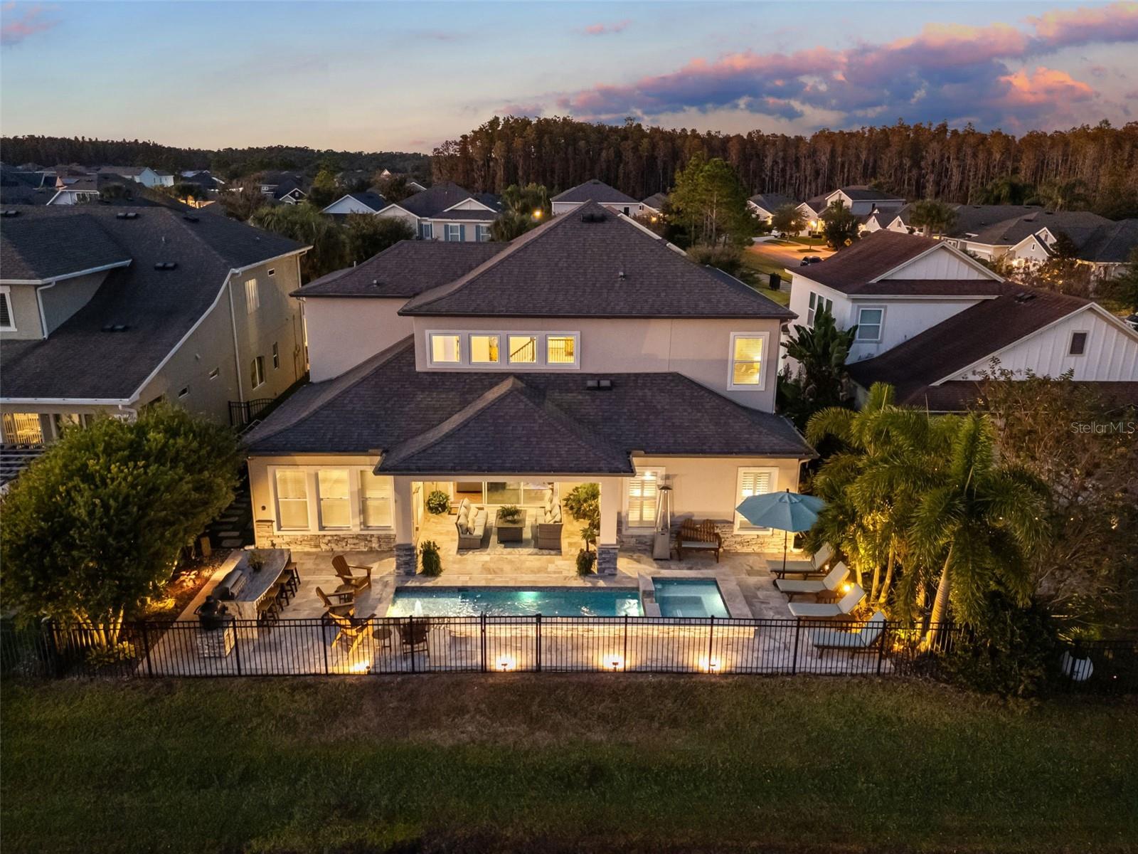 Heated saltwater pool & spa with app-controlled systems, and outdoor lighting