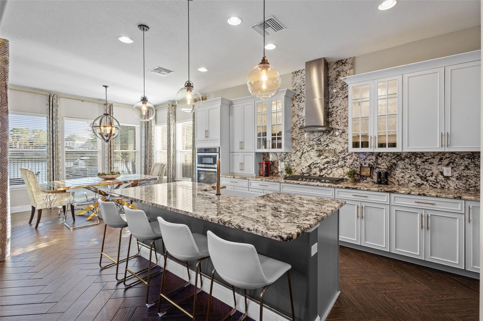 Upgraded chef’s kitchen with white cabinets & gray island