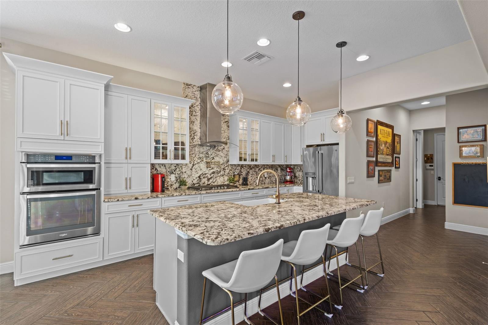 Upgraded chef’s kitchen with white cabinets & gray island