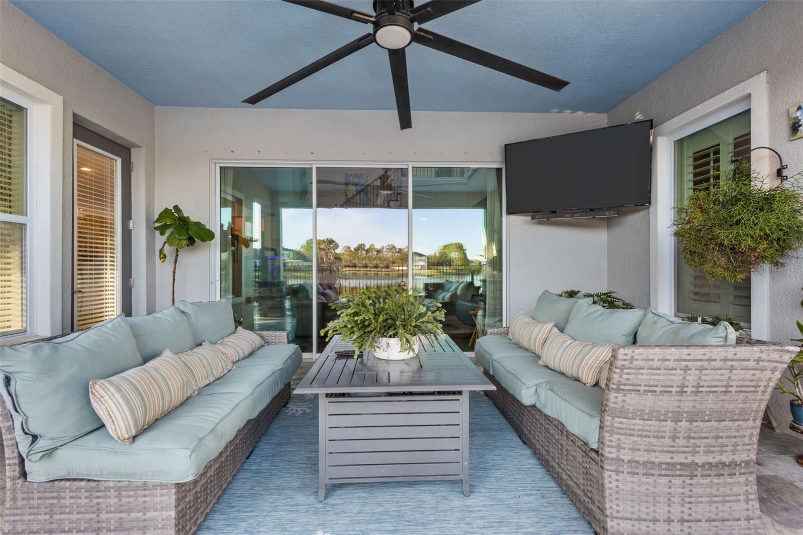 Covered lounge area with fire feature & tropical feel