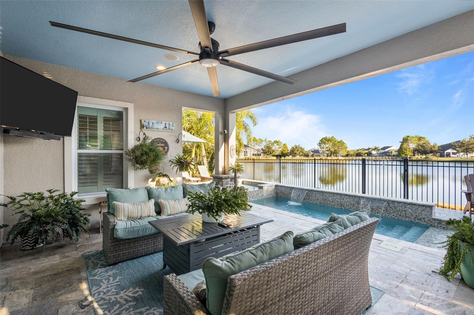 Covered lounge area with fire feature & tropical feel