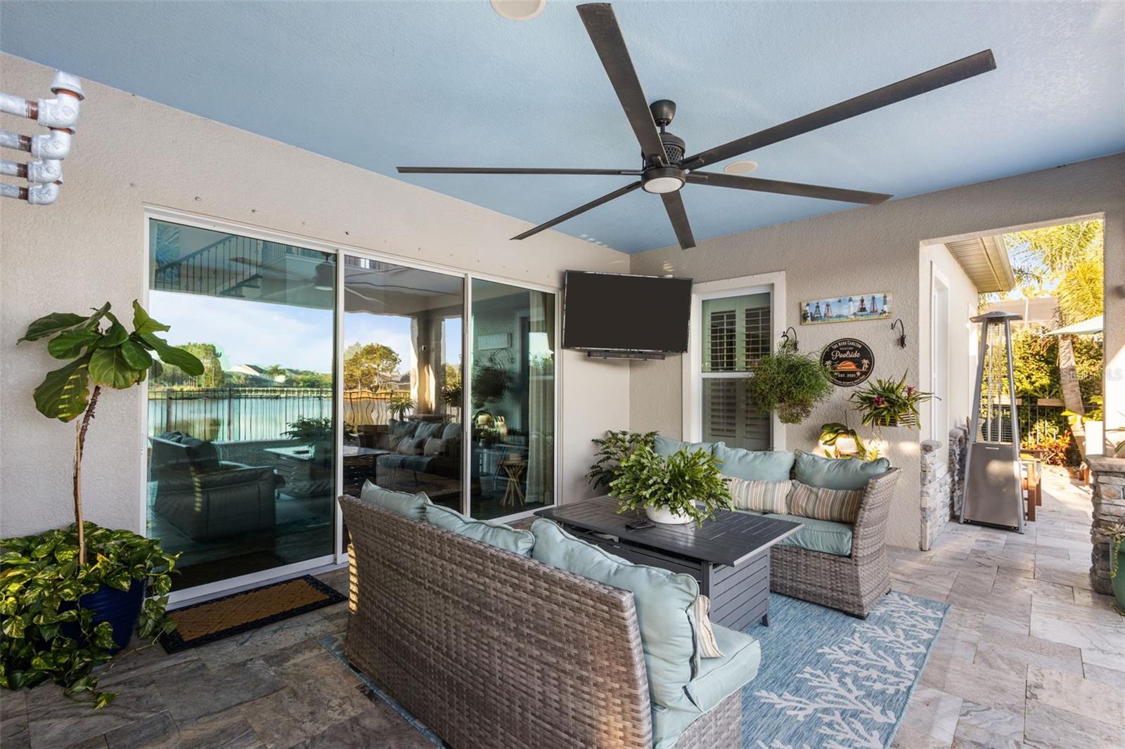 Covered lounge area with fire feature & tropical feel