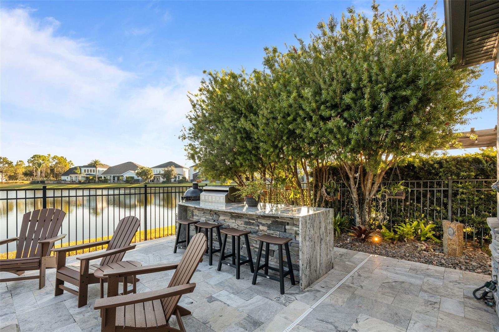 Full outdoor kitchen with Blaze appliances & bar space