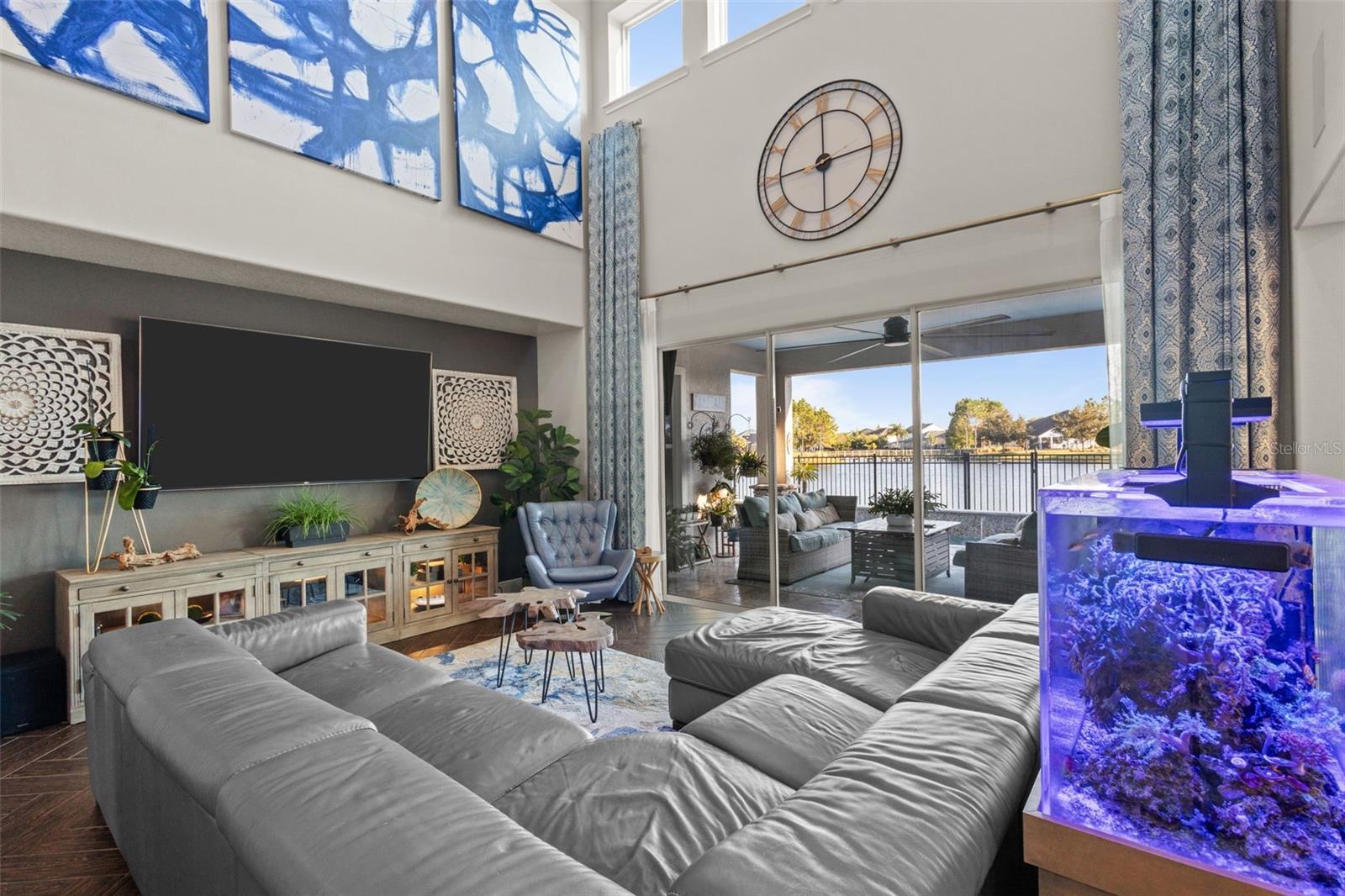 Soaring ceilings, exposed beams & pond views