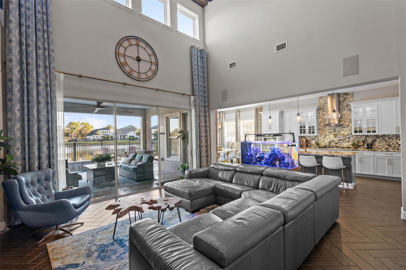 Soaring ceilings, exposed beams & pond views