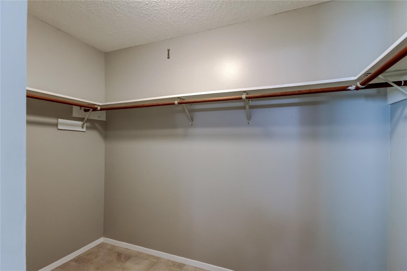 Expansive walk-in closet offering impressive linear hanging space, perfect for keeping wardrobes organized and easily accessible.