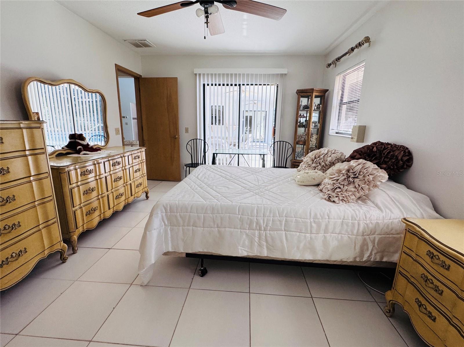 Second Primary Bedroom with sliders to the pool.