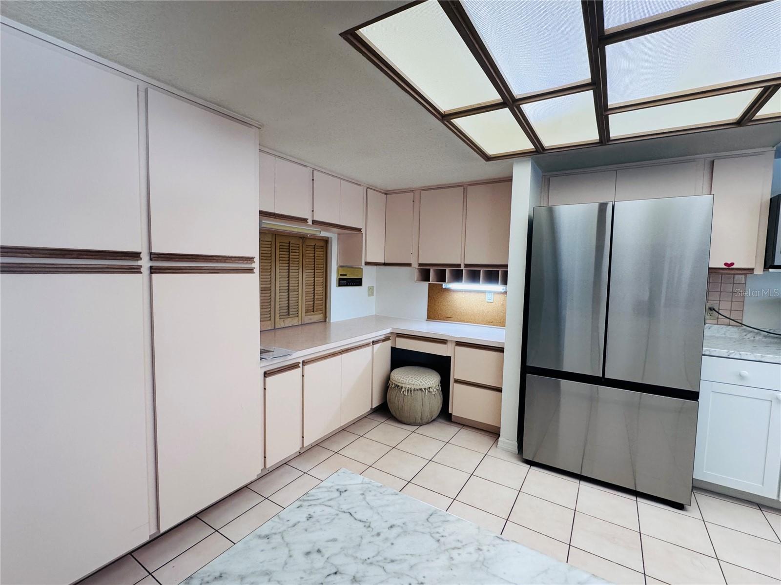 Large kitchen with tile flooring.