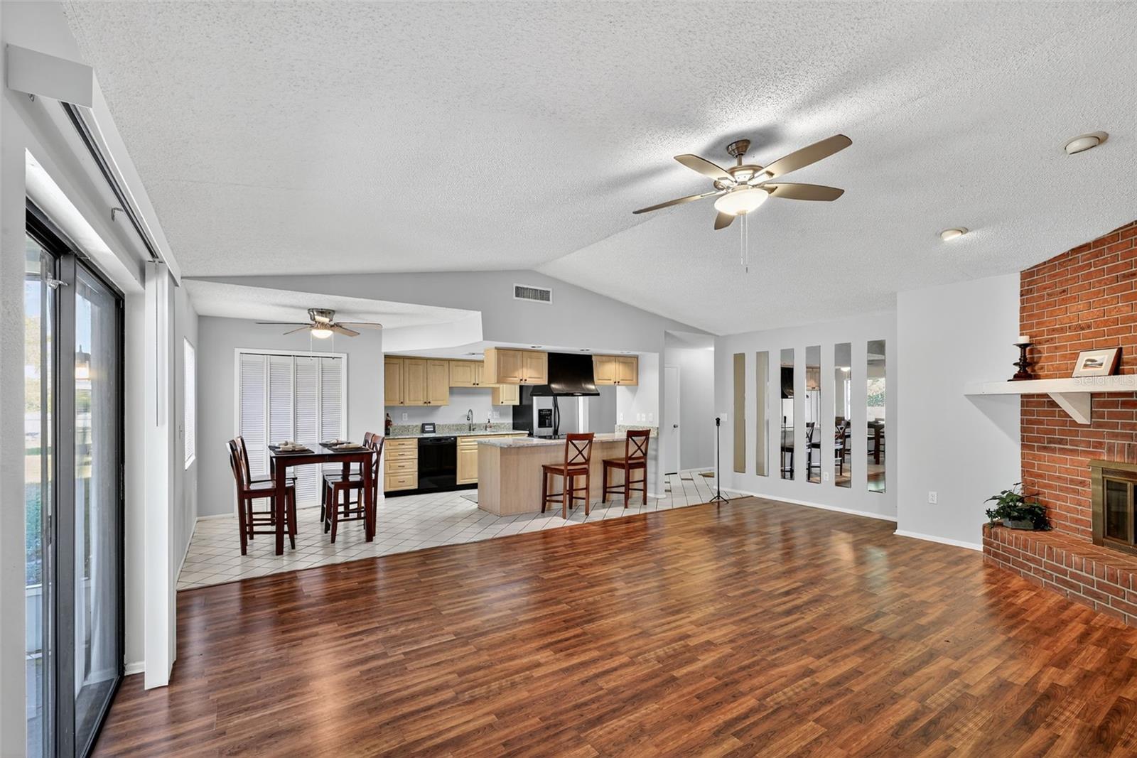View of living room, kitchen, and dining area
