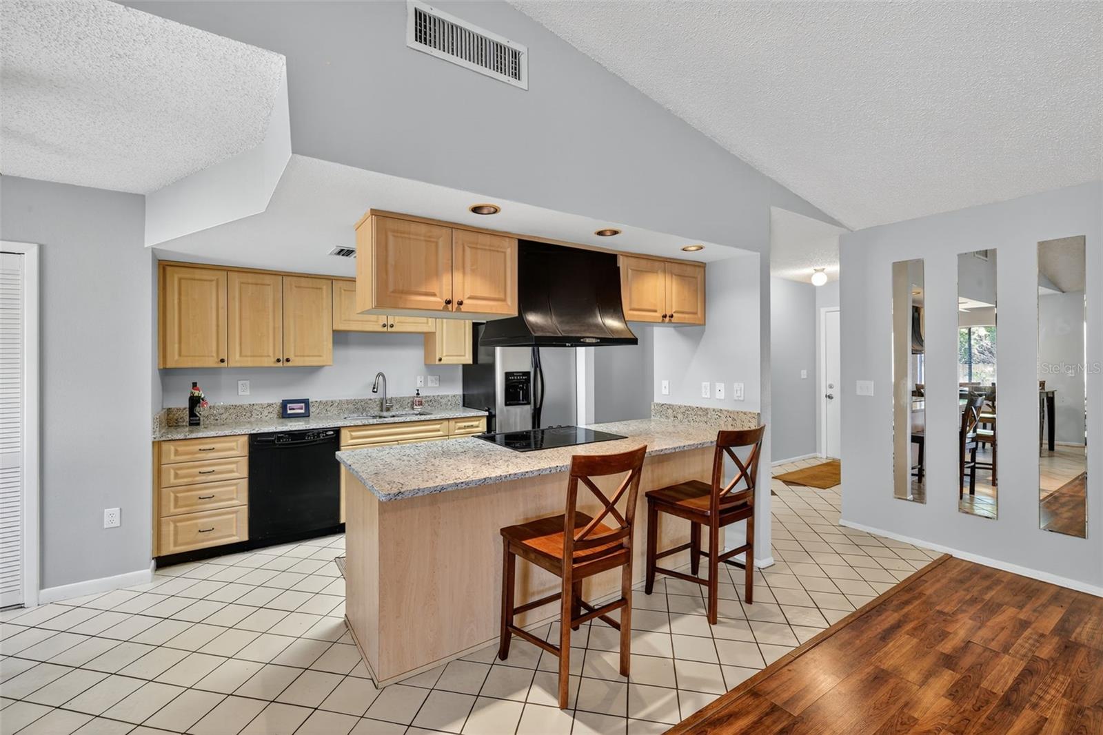 View of kitchen with bar stools