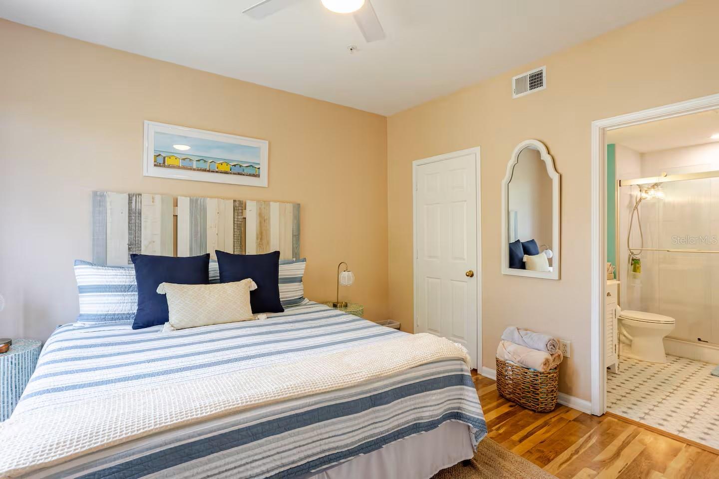 Large bedroom with King Bed, Ceiling Fan, Walk-in Closet and En-Suite Bathroom.