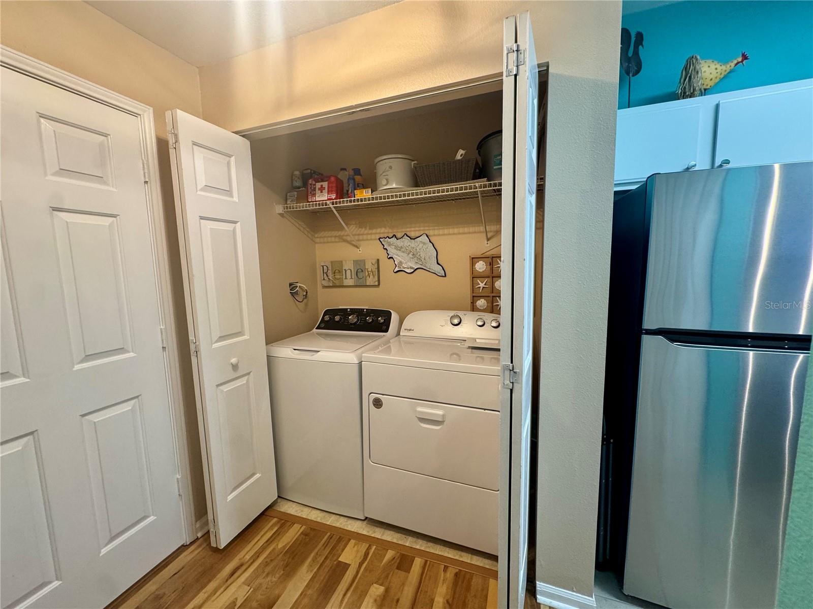 Washer and Dryer closet conveniently located next to kitchen.