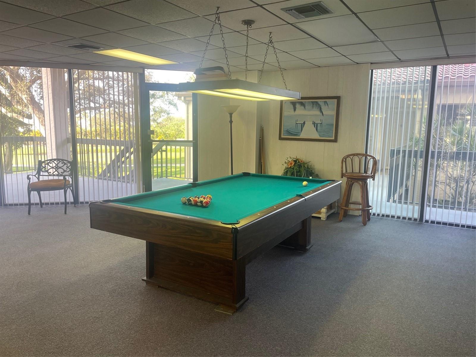 Club house with pool table. View out to patio