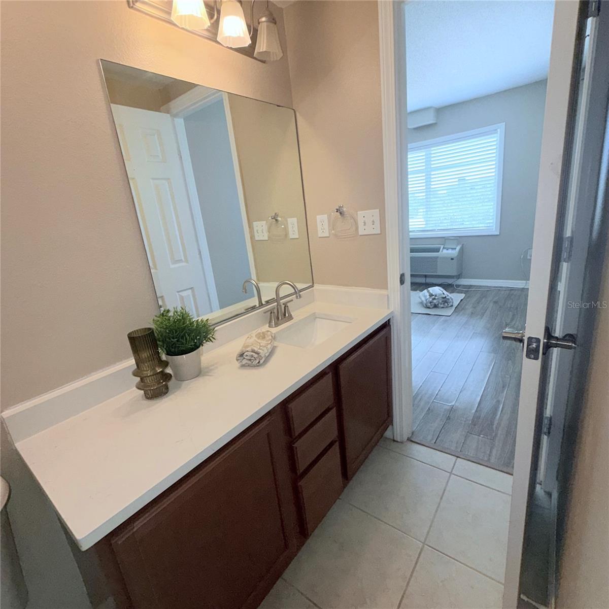 Bathroom number two full with a stand in shower quartz countertop new faucet 2026