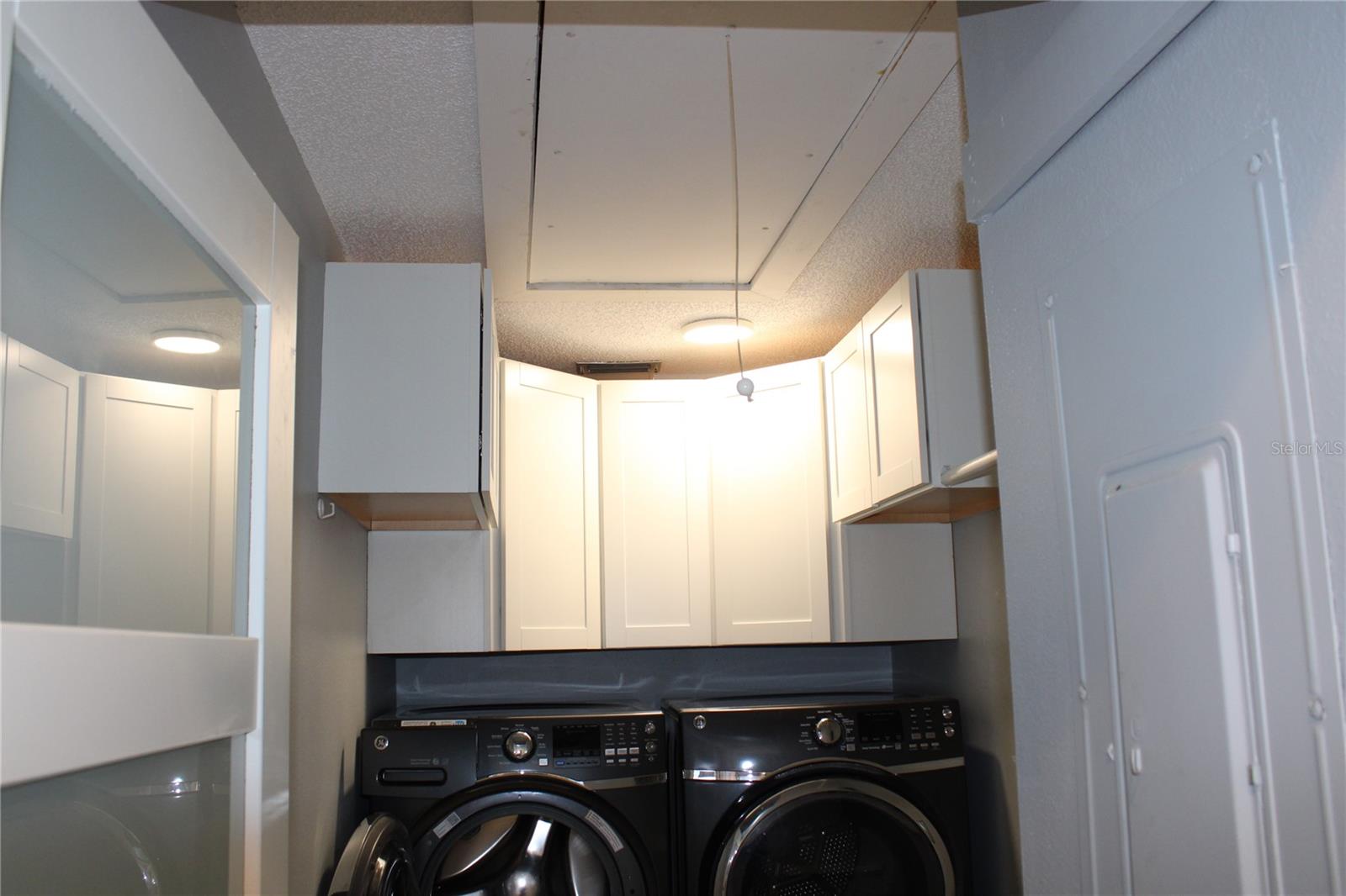 Pull down attic ladder opens to mega storage.