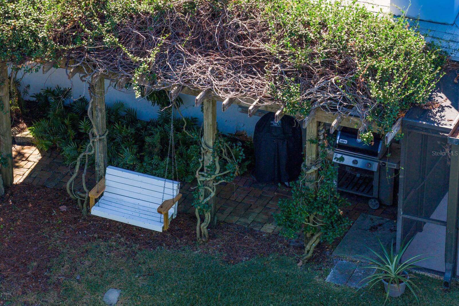 Private Pergola with porch swing and grill area